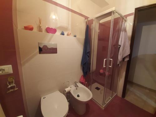 a bathroom with a toilet and a shower and a sink at Ciuri Ciuri - sea of Taormina in Letojanni