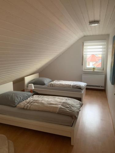 a bedroom with two beds and a window at Casa Blanca 3 in Ottenheim