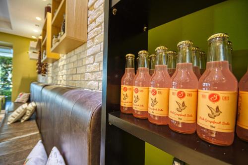 a row of bottles on a shelf in a bar at Island Boutique Hotel in Rhodes Town
