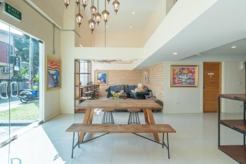 a living room with a table and a couch at Little Bear's Home in Chiang Mai