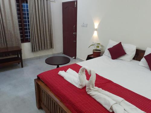 a hotel room with a bed with towels on it at Nature Villa Kochi in Alwaye