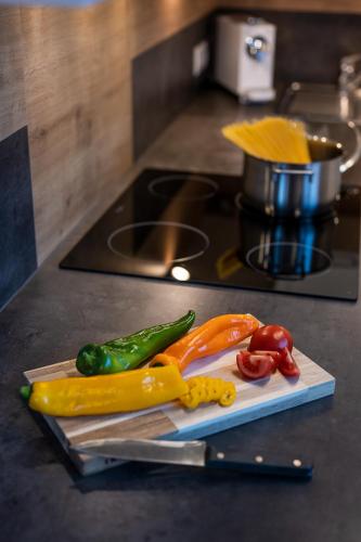 a pile of vegetables on a cutting board next to a knife at Tobhartbauer in Dorfgastein