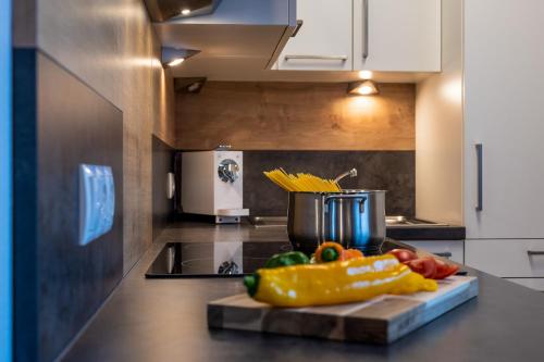 a kitchen with a cutting board with vegetables on a counter at Tobhartbauer in Dorfgastein
