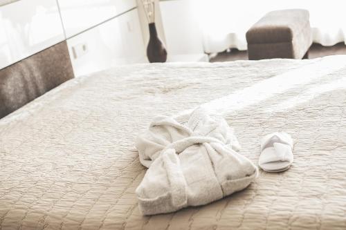 a white towel is laying on a bed at sky FLAT jacuzzi sauna 27 FLOOR in Klaipėda