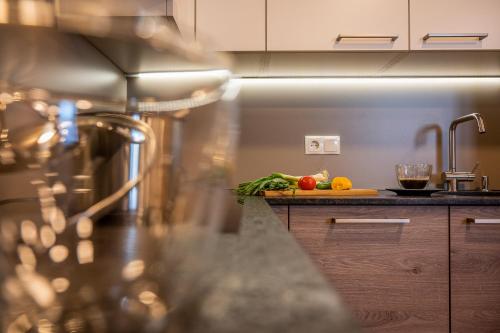 a kitchen with a counter with vegetables on a cutting board at Tobhartbauer in Dorfgastein