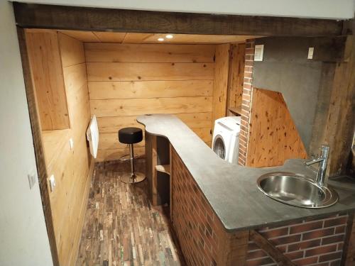 a small kitchen with a sink and a microwave at Bord de Loire in Gien