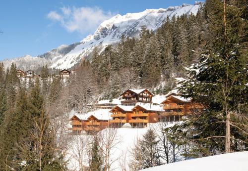 a log cabin in the snow with a mountain at Racers Retreat #5 in Wengen