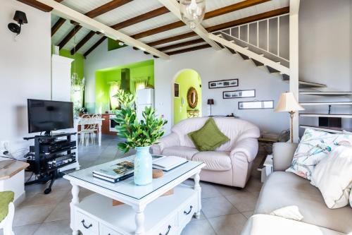 a living room with a couch and a table at Villa Amaryllis by Kardous in Alikias