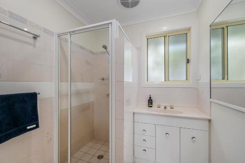 a bathroom with a shower and a sink at Bellhaven 2, 17 Willow Street in Crescent Head