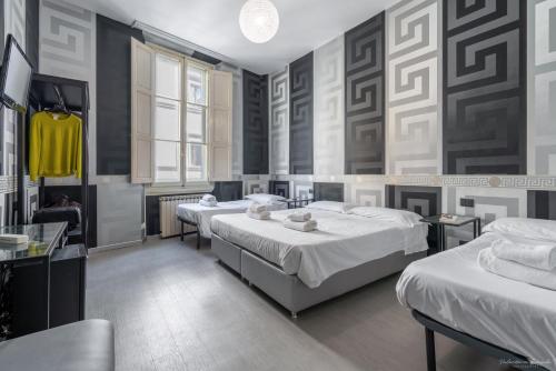 a bedroom with two beds and two tables at Hotel Spagna in Florence