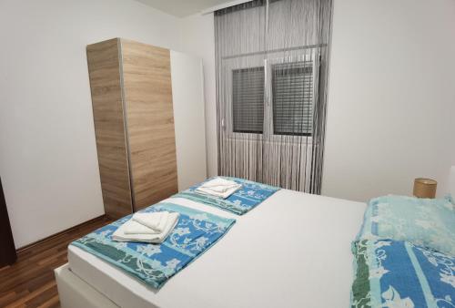 a bedroom with a bed with two towels on it at Apartments Beciri in Sveti Vid-Miholjice