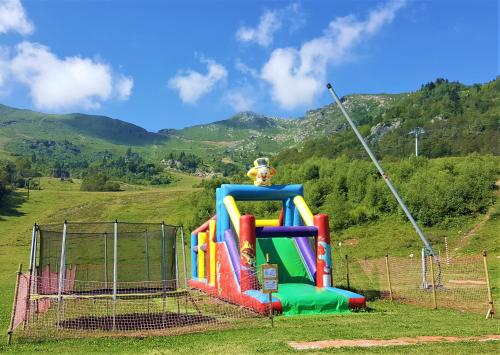 a playground with a slide in a field at Appartement au pied des Pistes de Ski - Pyrénées (Ariège) in Montferrier