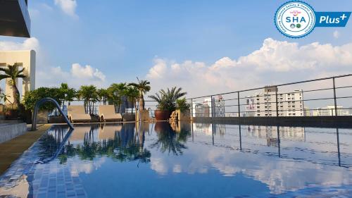 a swimming pool on the roof of a building at Interchange Tower Serviced Apartment - SHA Extra Plus in Bangkok