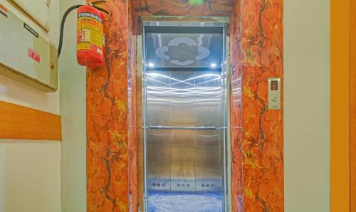 an empty refrigerator in a room with a wall at Treebo Sidhartha Inn Baliapanda in Puri
