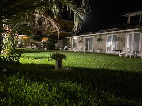 a house with a yard at night with a plant in the grass at Amantea Monument in Terrasini