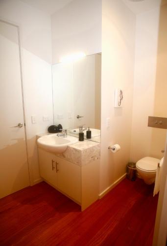 a bathroom with a sink and a toilet at Hilltop Apartments Phillip Island in Cowes