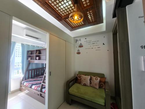 a small childs room with a chair and a crib at Cool at Wind Residences Tagaytay with FREE Use of Parking Space at Basement Building in Tagaytay
