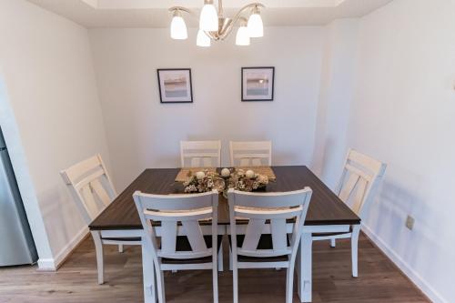 a dining room with a table and chairs at Handsome 2BR Condo with Gorgeous Views in Sugar Mountain! condo in Sugar Mountain