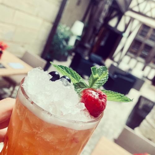 a drink with a strawberry and a raspberryasteryasteryasteryasteryasteryasteryasteryastery at Maison Philippe Le Bon Hôtel, Restaurant & Bar le 19 in Dijon