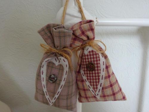 a pair of hearts hanging on a wall at Yew Tree Farm in Congleton
