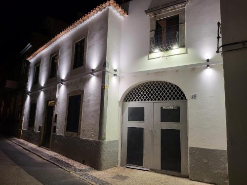 
a building with a clock on the front of it at Faro Town House in Faro
