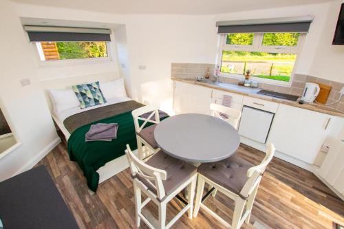 a small room with a table and a table and chairs at Waterfall Caves in Limavady