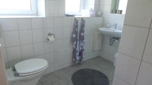 a bathroom with a toilet and a sink at Ferienwohnung am Kurpark in Bad Münder am Deister