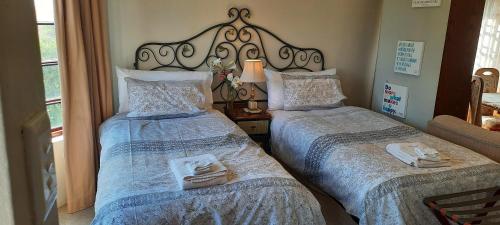 a bedroom with two beds with towels on them at MyAula in Tierpoort