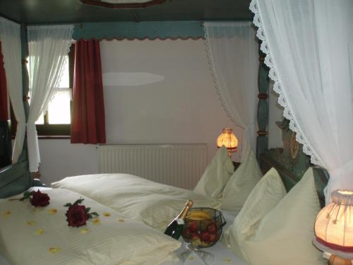 a bedroom with a bed with flowers on it at Naturhotel Hüttenwirt im Grossarltal in Hüttschlag