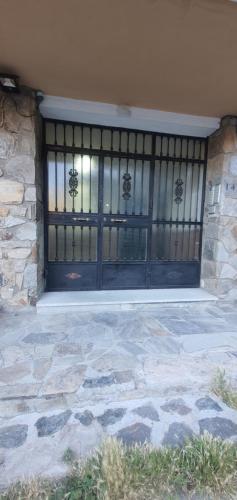a front door of a house with a stone at Slalom BG Sierra Nevada in Sierra Nevada