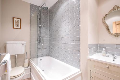 een badkamer met een bad, een toilet en een wastafel bij 4 Market Cross House Aldeburgh Air Manage Suffolk in Aldeburgh