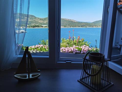 a room with a window with a view of the water at Sailor's Delight in Kavala