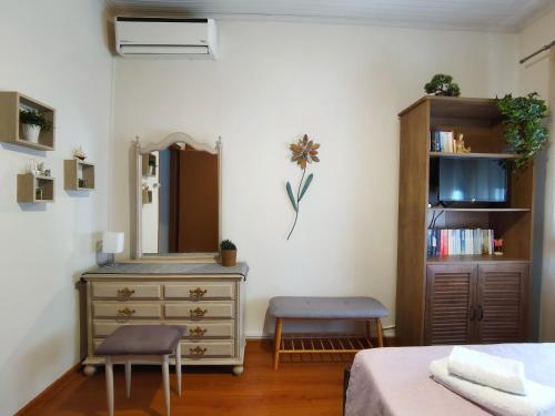 a bedroom with a dresser and a mirror at Sailor's Delight in Kavala