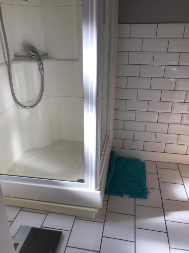 a white bathroom with a shower and a tub at Melrose cottage in Goring