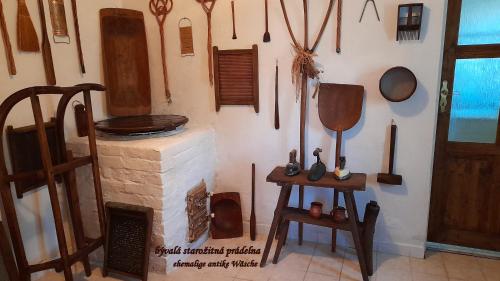 a room with a wall filled with wooden utensils at Chalupa Medium in Krásná Lípa