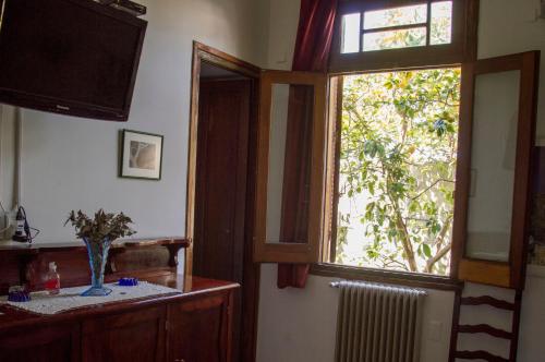 a living room with a window and a television at Cane B&B in Montevideo
