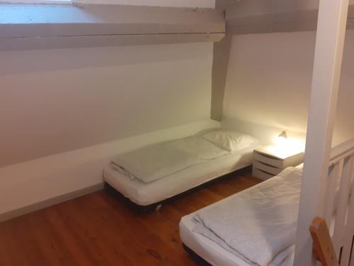 a small bedroom with two beds and a window at Domaine de Keravel in Plouha