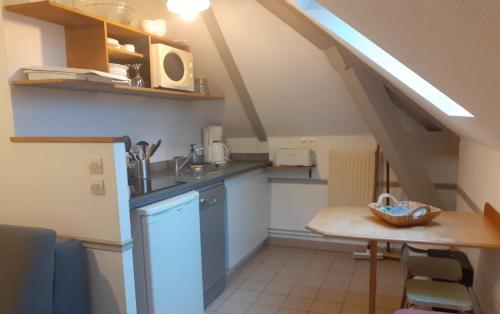 a small kitchen with a sink and a table at Domaine de Keravel in Plouha