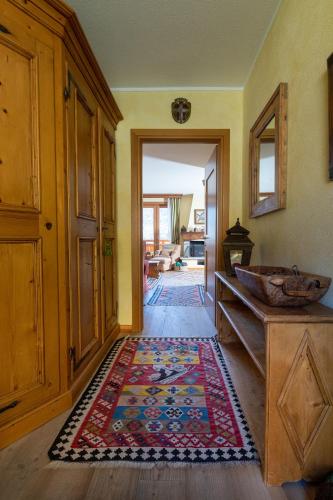 a hallway with a sink and a rug on the floor at Chalet Casericc in Bormio