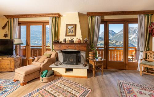 a living room with a couch and a fireplace at Chalet Casericc in Bormio
