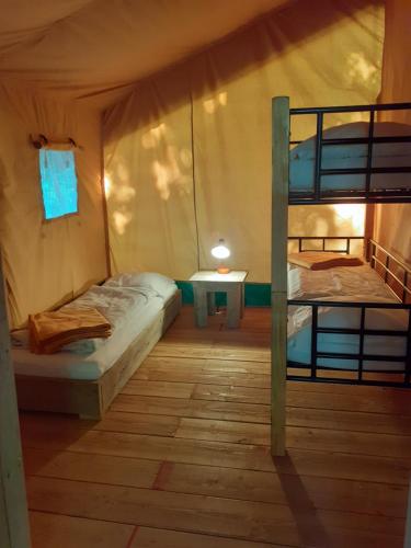 a room with two bunk beds and a table at Domaine de Keravel in Plouha