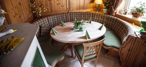 a wooden table and chairs in a room at Landhotel Gasthof Huber in Merching
