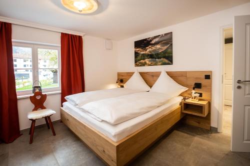 a bedroom with a large bed and a window at Alpin Supreme in Oberstdorf