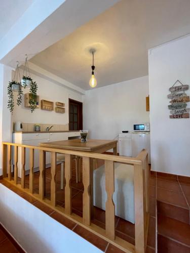 a kitchen with a wooden table in a room at Estúdio Albergaria in Albergaria-a-Velha