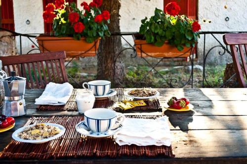ein Holztisch mit Tellern voller Essen darauf in der Unterkunft B&b Parco Alta Murgia in Cassano delle Murge