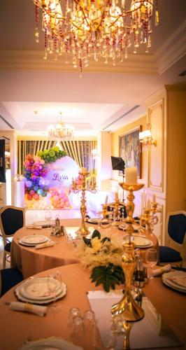 a dining room with a table and a chandelier at Hotel Fieri in Fier