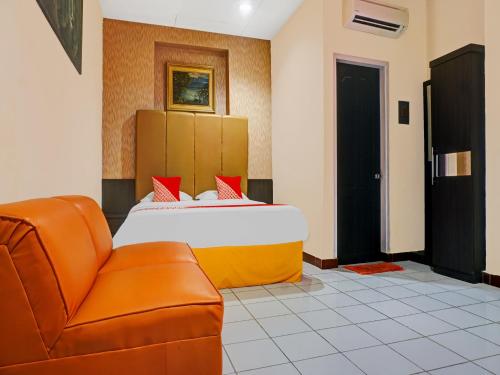 Säng eller sängar i ett rum på OYO 924 Hotel Bali