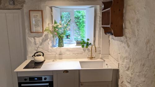 a kitchen with a sink and a window at The Hideaway in Falmouth