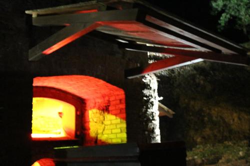 an outdoor brick oven with a fire in it at Pensión NAVIA A Pontenova in A Pontenova