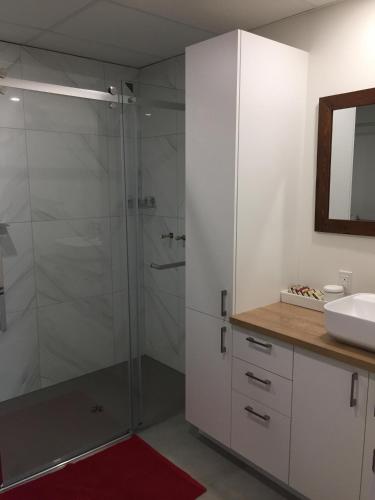 a glass shower in a bathroom with a sink at Chalet Du Bonheur in Sainte-Germaine-du-Lac-Etchemin